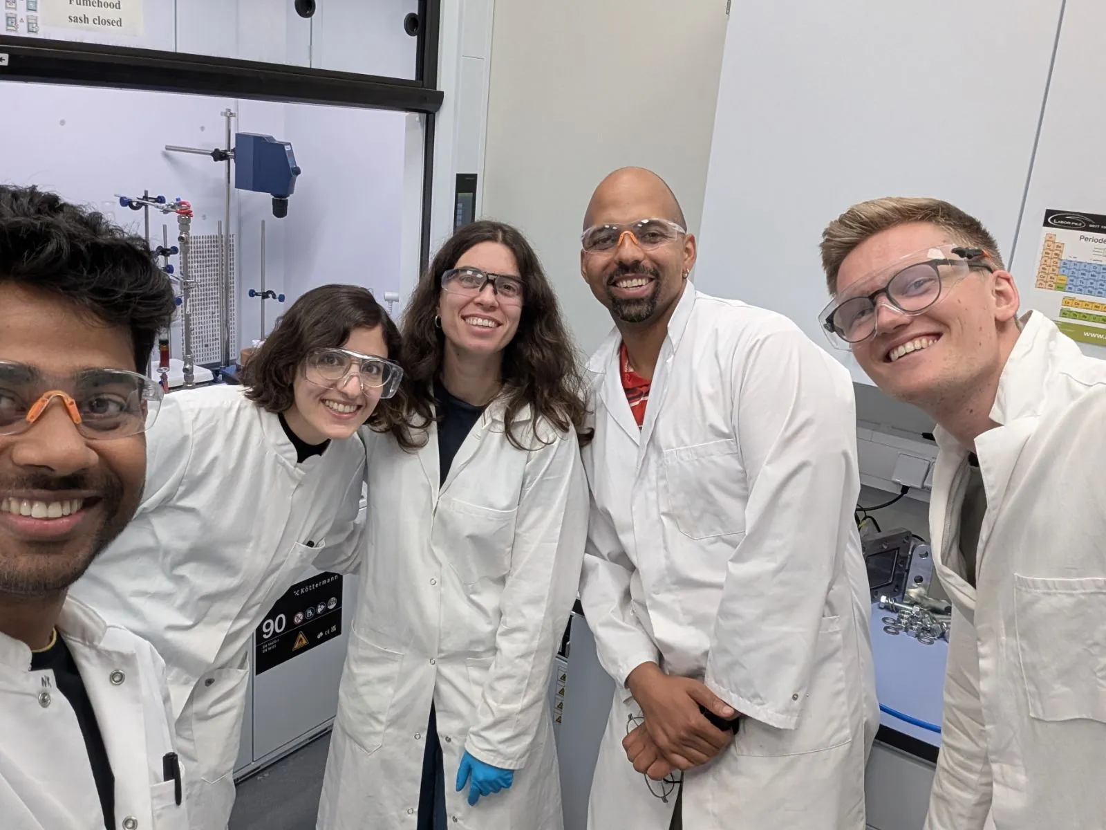 NeoCarbon scientists in lab coats and safety glasses working in the chemistry lab